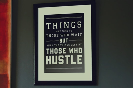 Free hustle quote art print in frame on wall