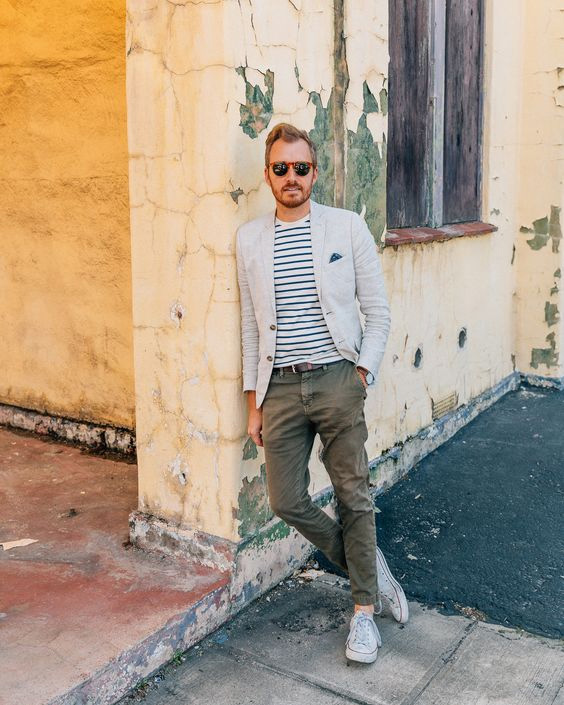 man wearing a linen blazer over a striped shirt with chinos and casual shoes