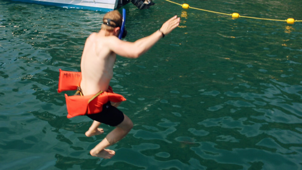 man jumping into ocean