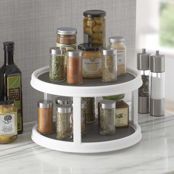 a space saving lazy susan storage turntable holding various jars
