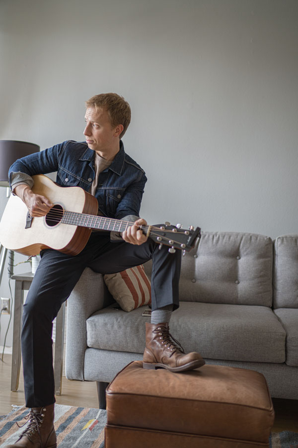 denim jacket beige sweater black pants brown boots men