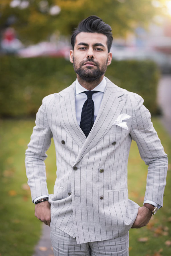 man in suit wearing cutaway collar shirt