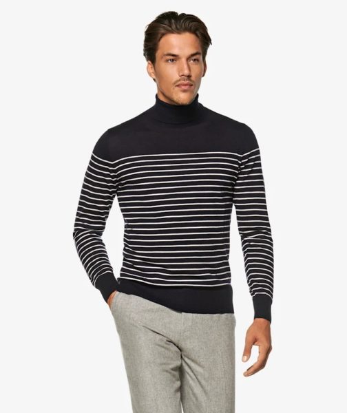 A man wearing a navy and white striped turtleneck top