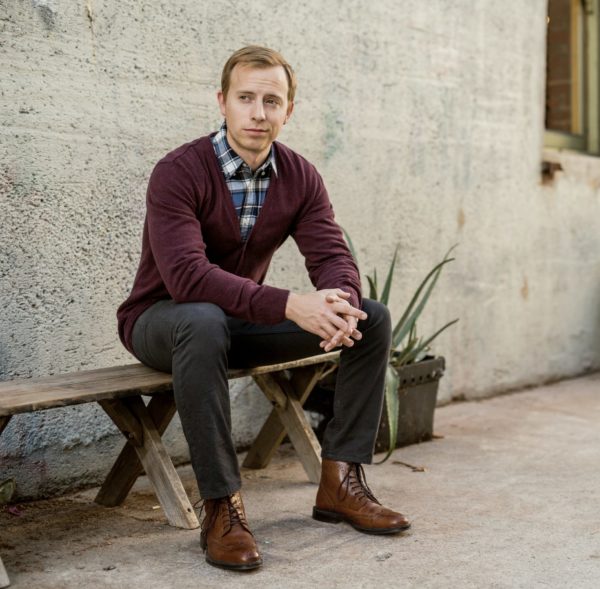 man wearing a cardigan sweater and dark colored pants for primer magazine
