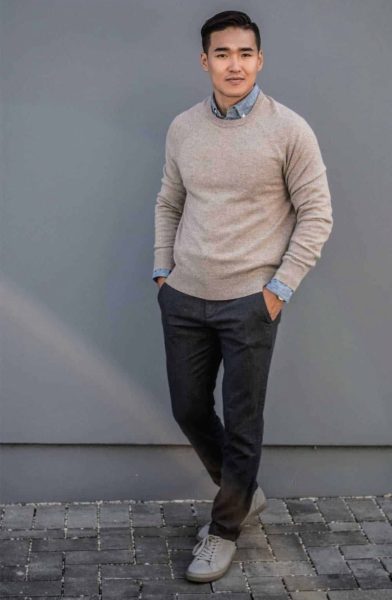 man wearing a v neck sweater and dark pants for primer magazine