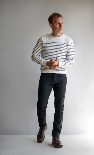 man wearing a striped sweater and dark pants for primer magazine