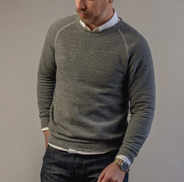 Andrew from Primer wearing a gray raglan sleeve sweatshirt