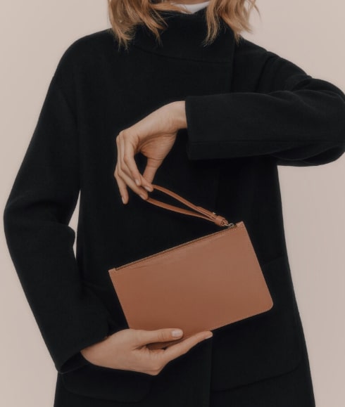 women holding a leather bag from cuyano brand