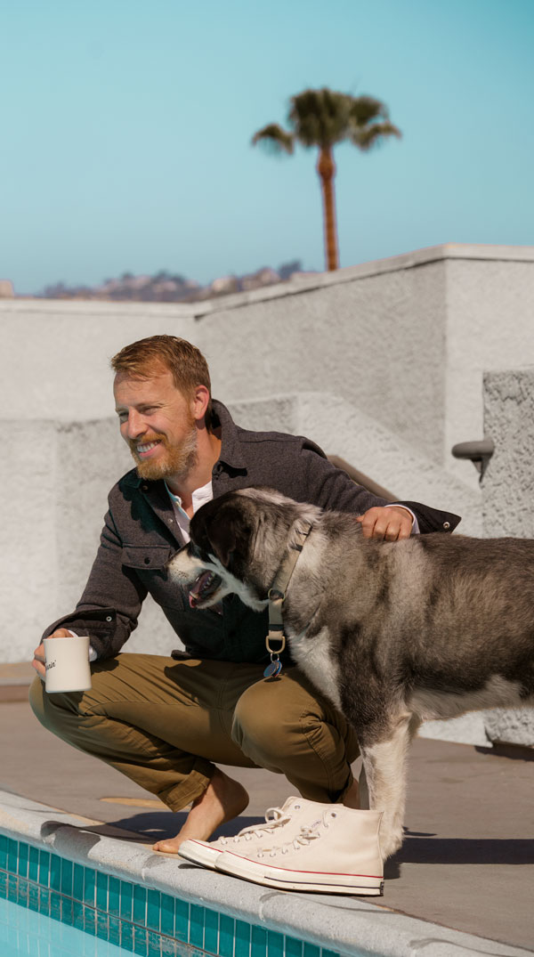 Andrew Snavely drinking coffee with his dog Leela