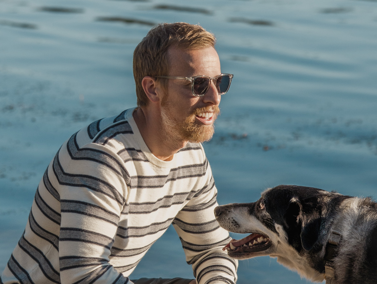 men clear sunglasses on man with dog