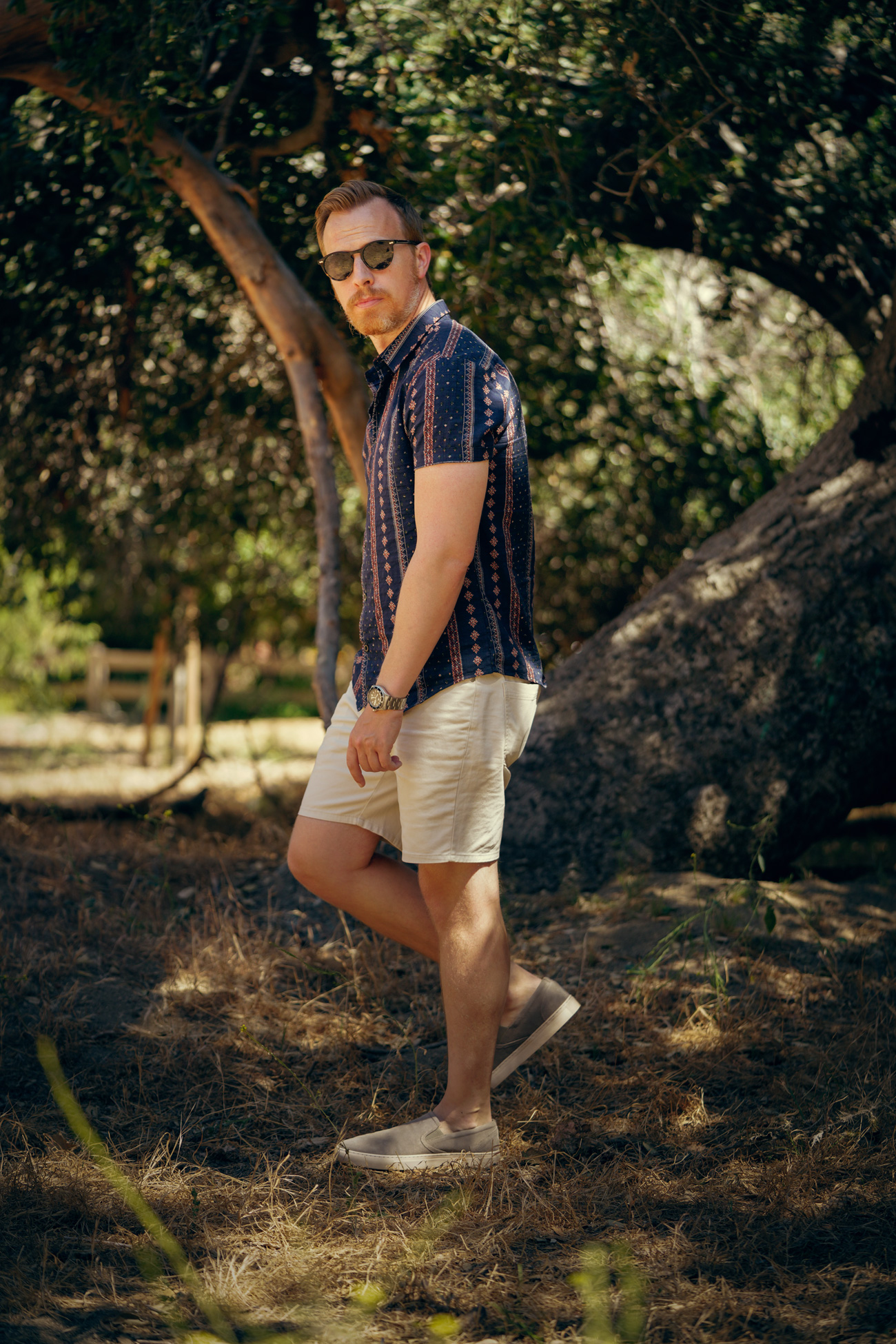 short sleeve floral shirt with white shorts and sneakers - mens summer outfit idea
