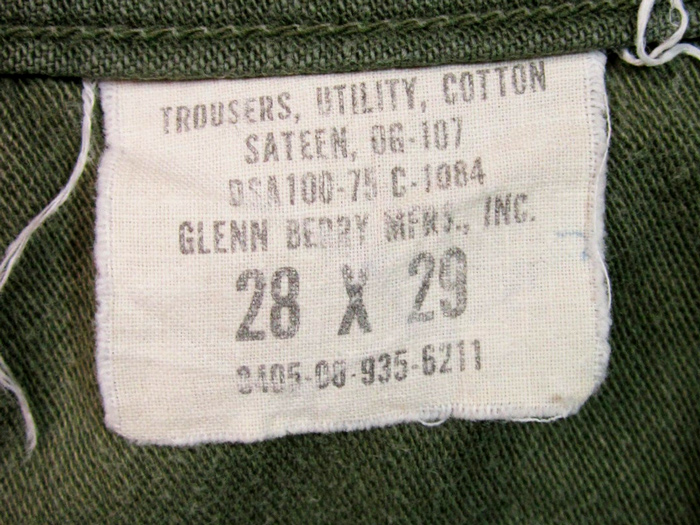 a clothing tag located inside fatigue pants listing materials and size measurments