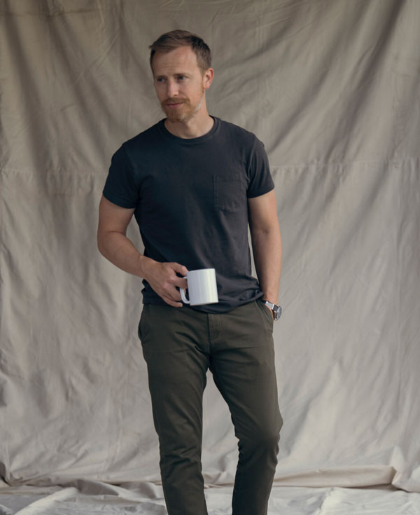 Andrew Snavely wearing black pocket t-shirt with green olive chinos in summer