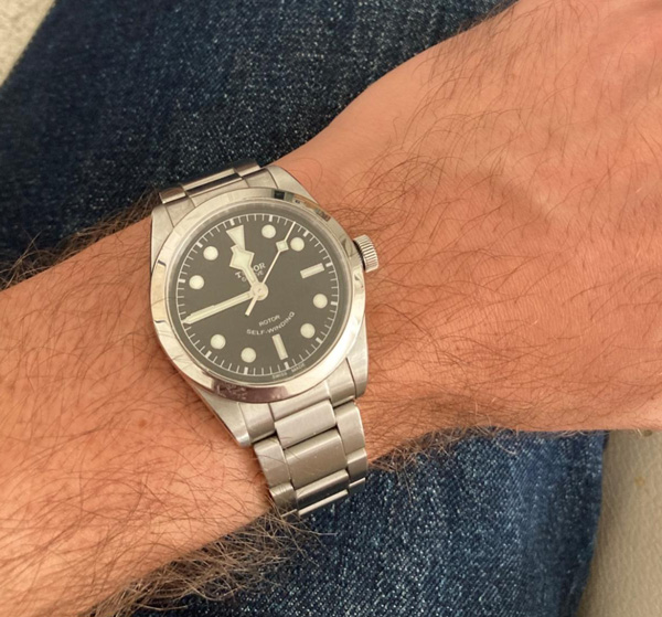 silver link watch band with grey face