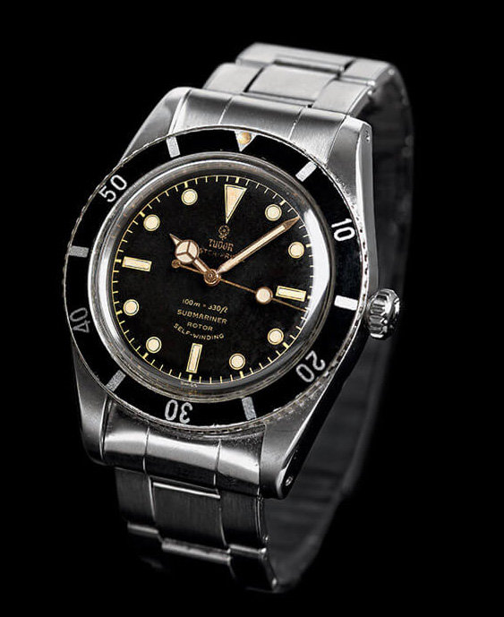 watch with silver metal link and black and gold face