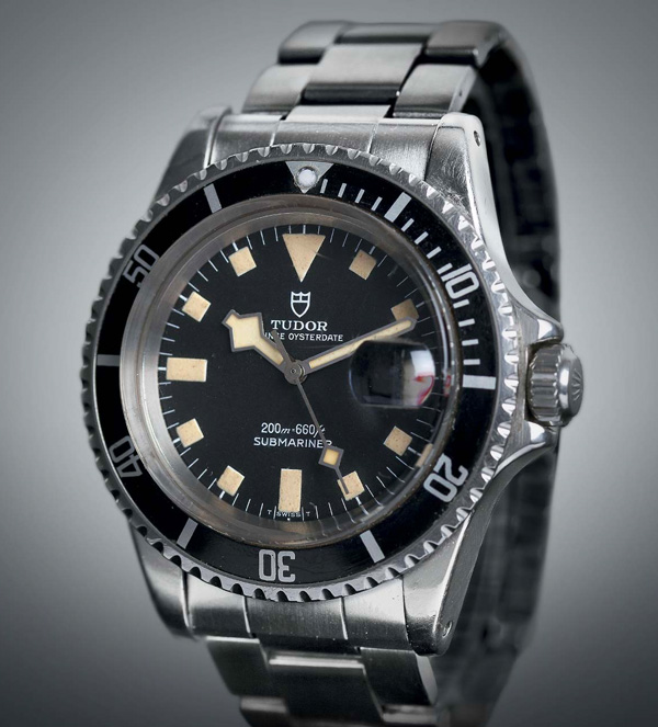 silver metal watch band with black face from tudor