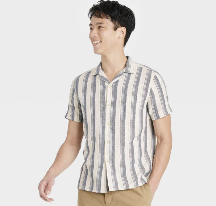 man wearing a blue and white striped short sleeve button down camp collar shirt