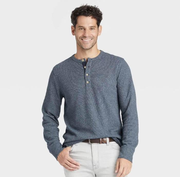 man wearing a light grey blue long sleeve henley shirt