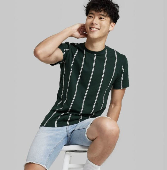 man wearing a green striped crewneck shirt