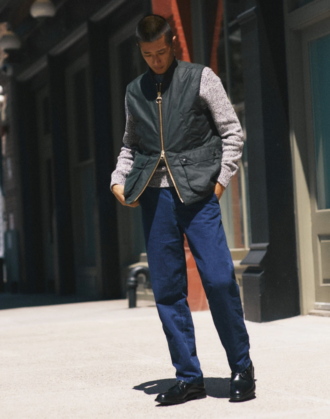 jcrew16 man wearing a green and grey jacket and blue pants