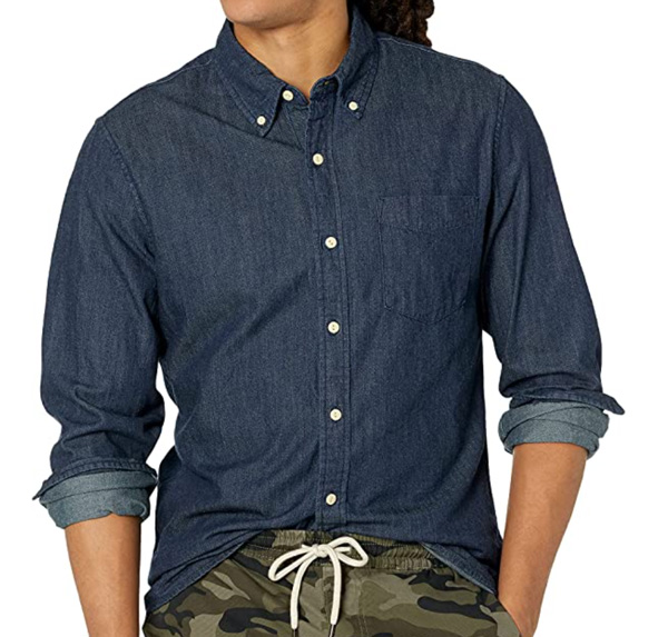 a man wearing a long sleeve button up denim dress shirt