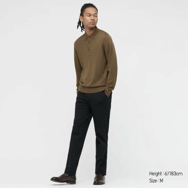 man wearing a long sleeve polo shirt and black pants