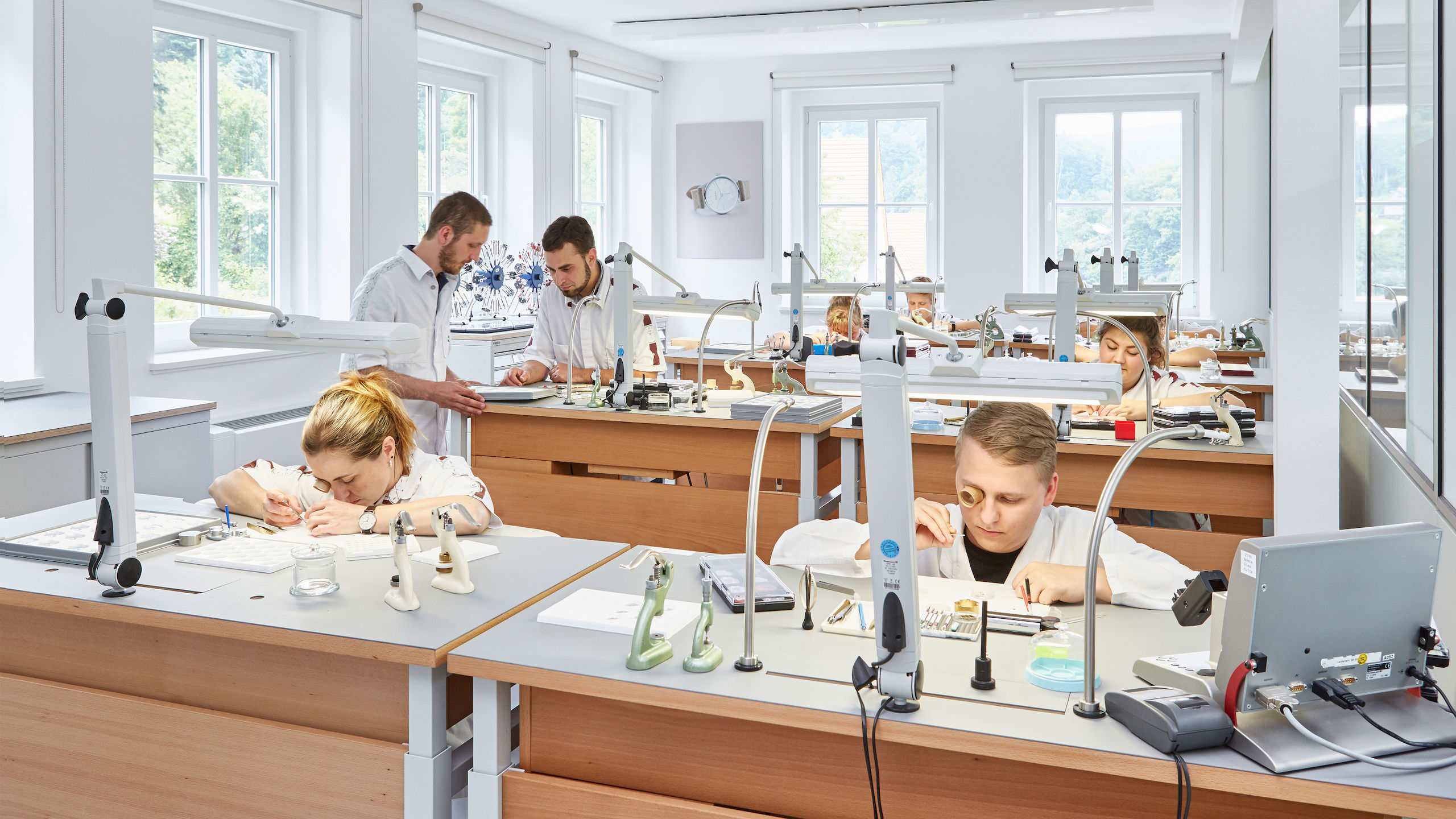 Image of people working in a watch making work space