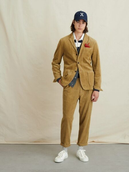 image of man wearing a brown corduroy suit and baseball cap