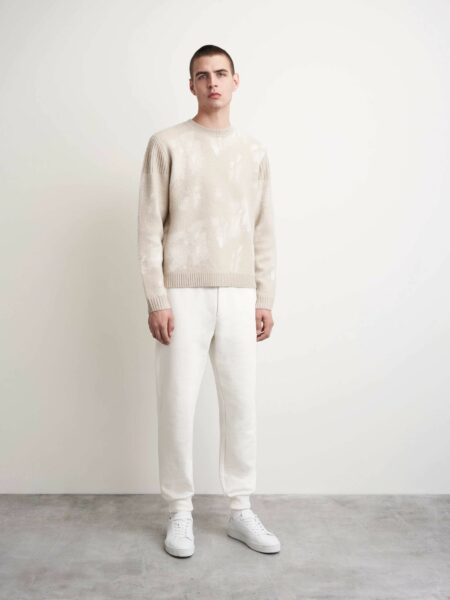 image of a man wearing a light colored sweater and light colored sweatpants