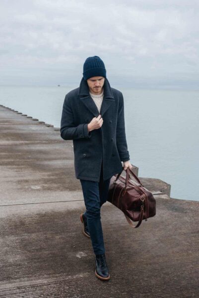 image of a man wearing a dark overcoat and a beanie hat