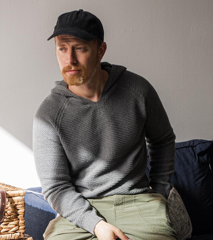 man wearing a grey knit hoodie