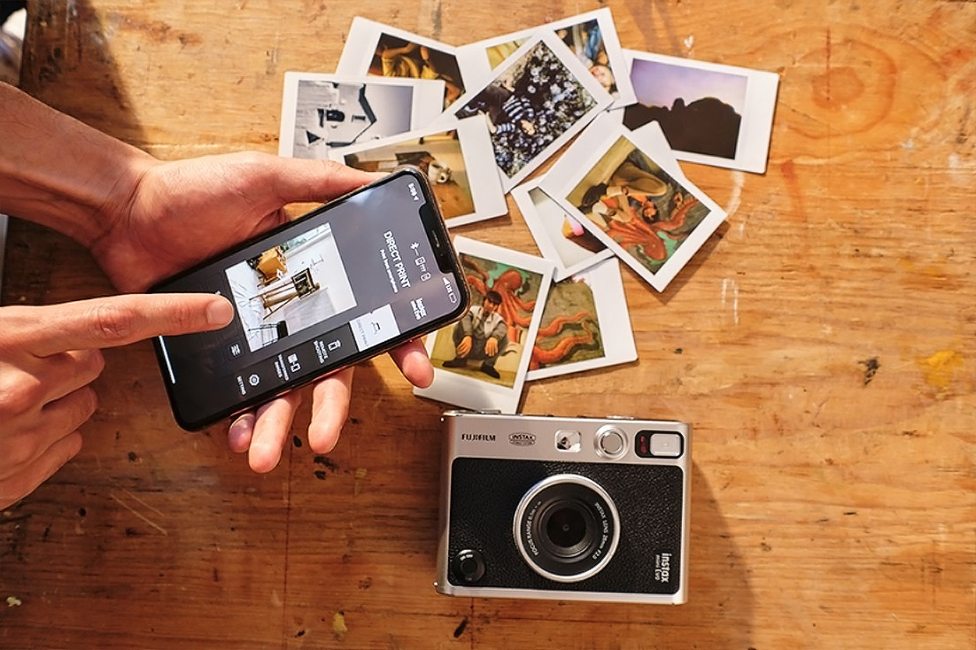 Fuji-instax image of printed photos and a camera