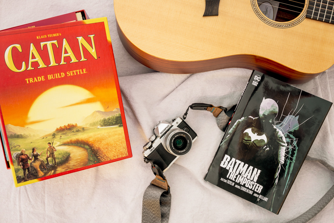 Summer-Survival-Guide photo of a board game, guitar, camera, and comic book