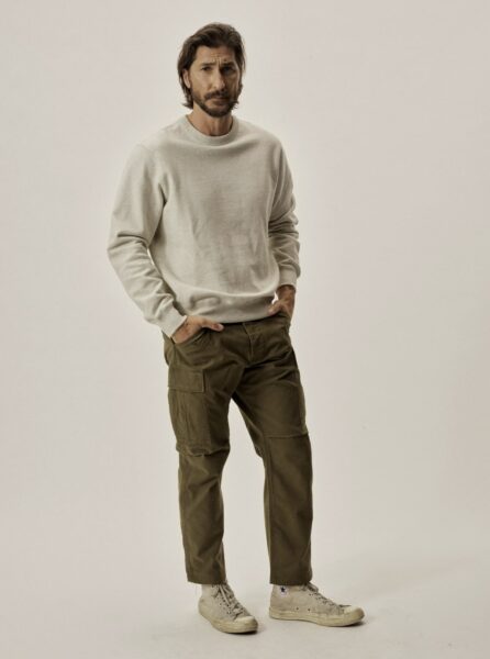 image of a man wearing a grey sweater and olive utility style pants