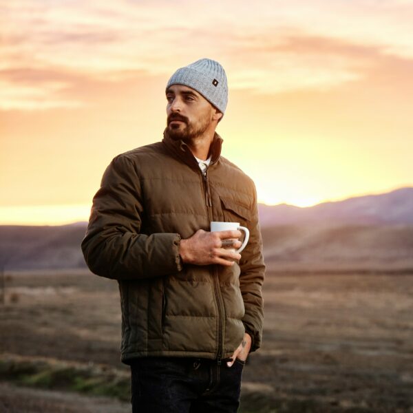 image of a man wearing a brown jacket and grey beanie hat