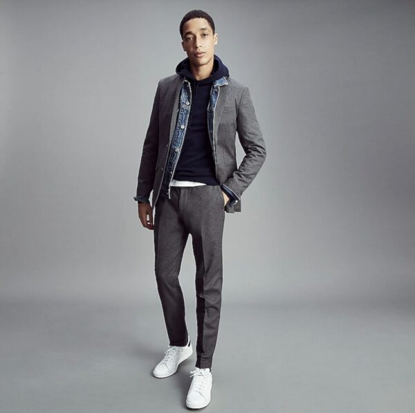 image of a man wearing grey pants grey jacket white shoes