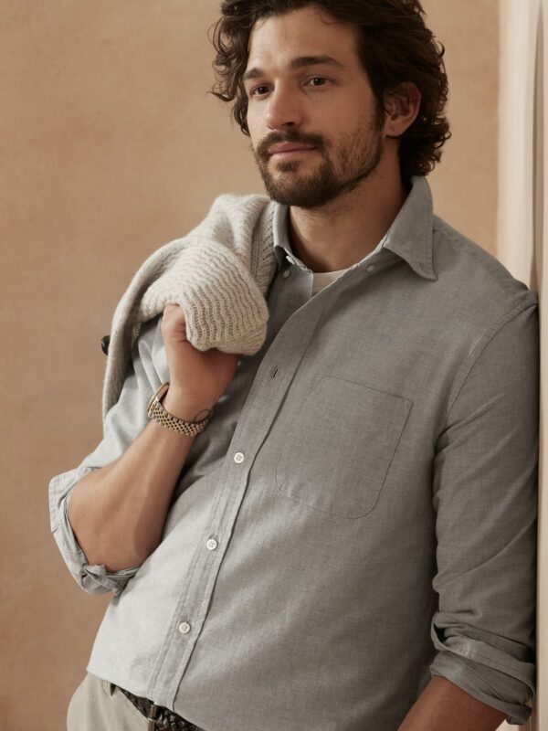 image of a man wearing a light grey oxford button up shirt