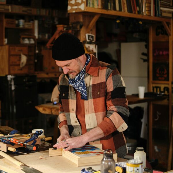 image of a man wearing a plaid patter work shirt