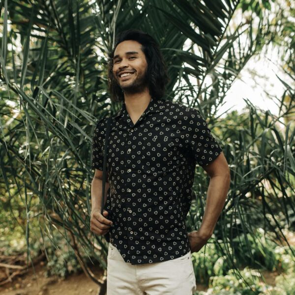 image of a man wearing a black short sleeve button down shirt