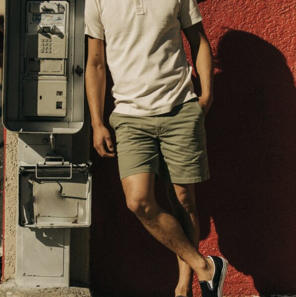 image of a person wearing olive green shorts and a white shirt