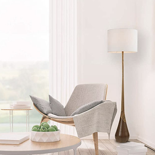 wood base floor lamp in the corner of a living room area