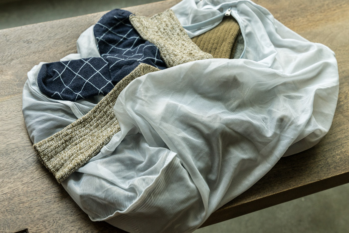 a mesh laundry bag with socks in it