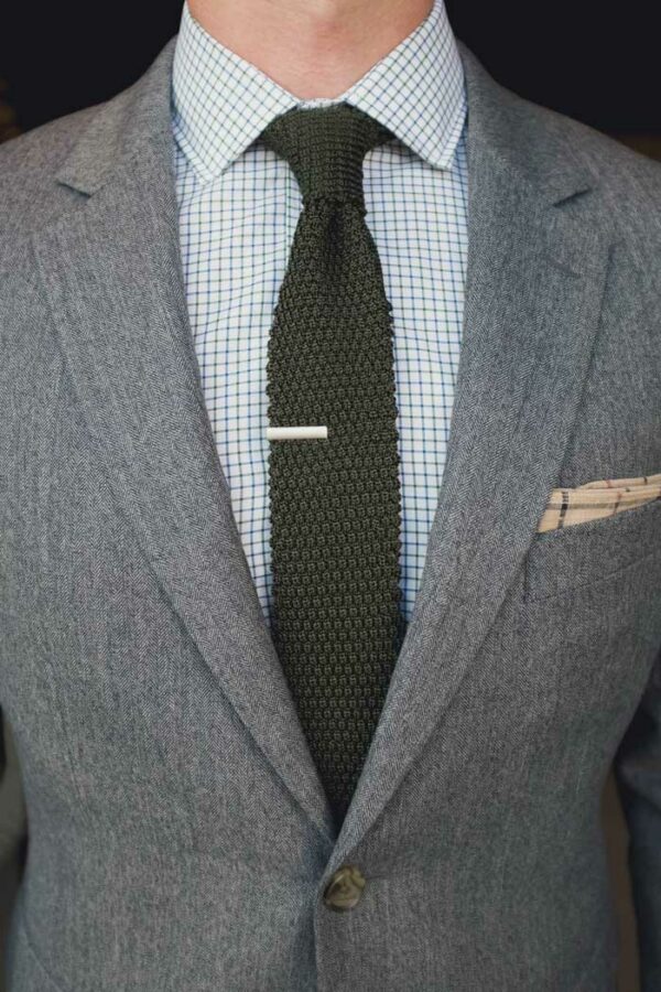 image of a textured tie and grey suit jacket