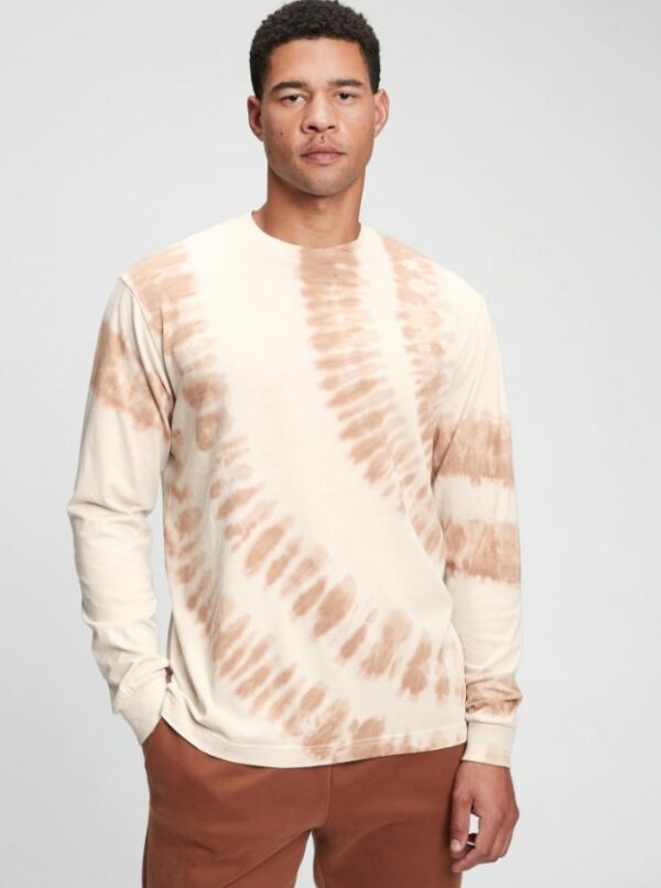 a man wearing a tie die pattern long sleeve shirt