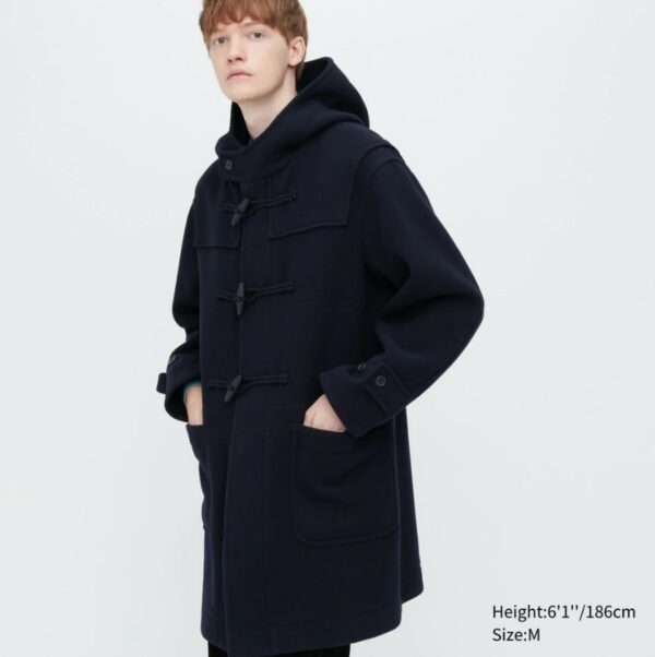 a man wearing a long black hooded overcoat