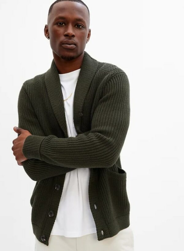 a man wearing a dark green cardigan over a white shirt