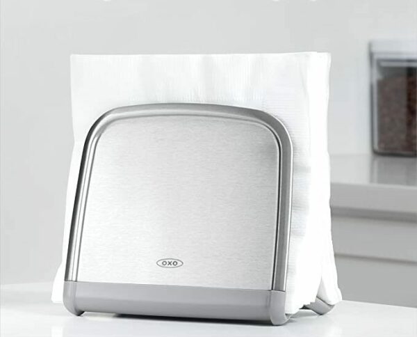 white paper napkins in a stainless steel napkin holder