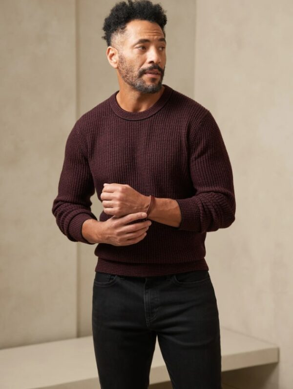 a man wearing a dark red striped sweater