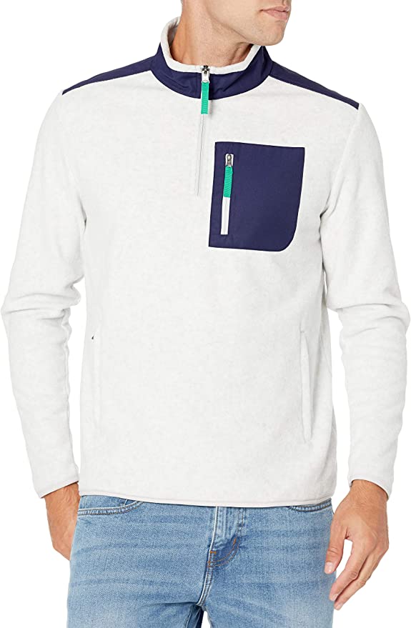 man wearing a white polar fleece style jacket with dark blue pocket design