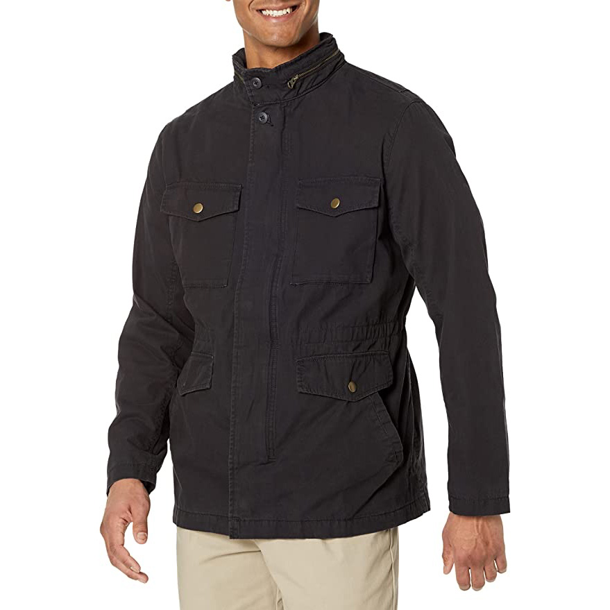 a man wearing a black utility style jacket